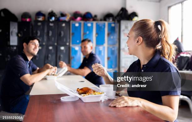 group of blue-collar workers eating in their lunch break - cantina imagens e fotografias de stock
