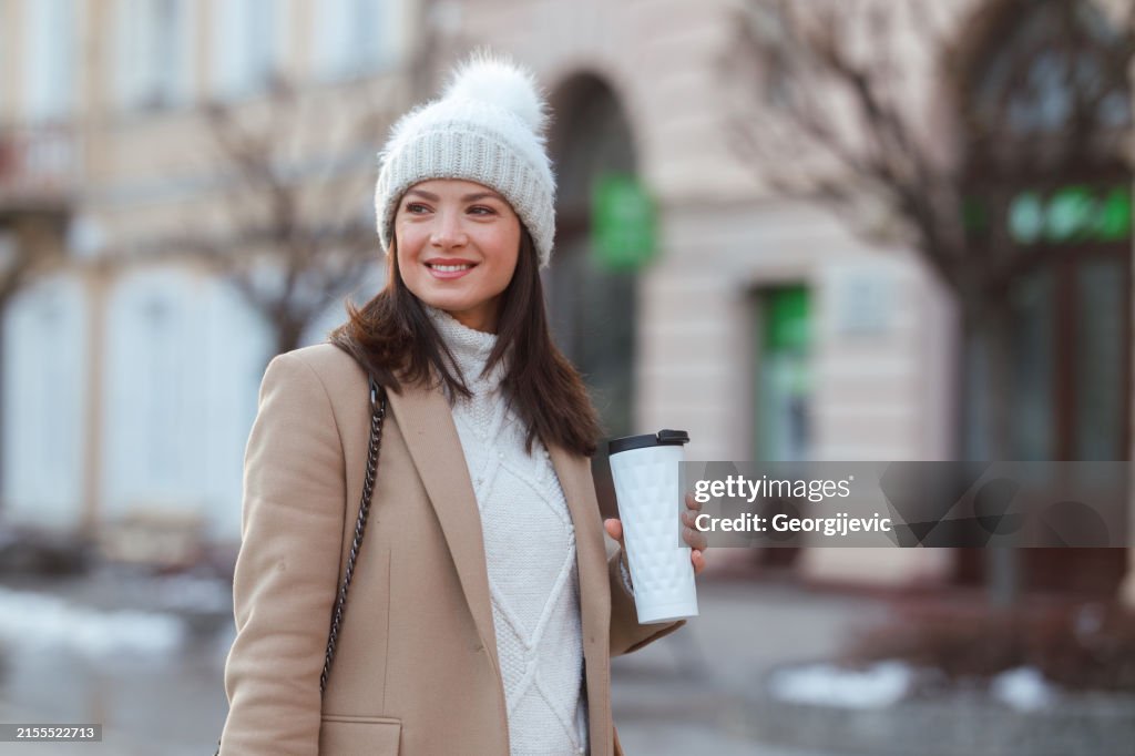 A Caucasian Woman Strolls Along a City Street