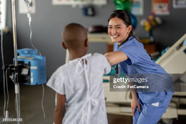 waiting through chemo - elbow bump stock pictures, royalty-free photos & images