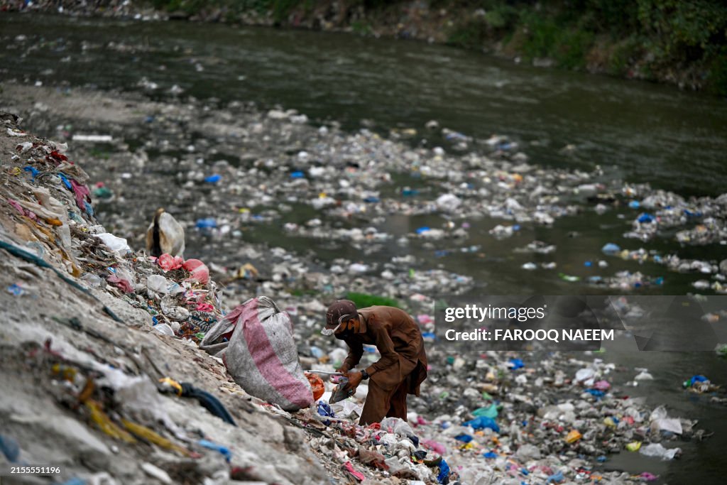 Pakistan Rag A rag-picker searches for recyclable items on World Environment Day ...