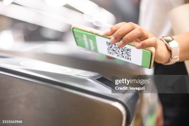 young asian woman using smartwatch checking in at subway station - train ticket stock pictures, royalty-free photos & images