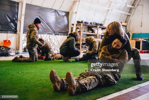 Participants learn how to apply a tourniquet during stop the bleed training on a Tactical Combat Casualty Care course by the Hospitallers Medical...
