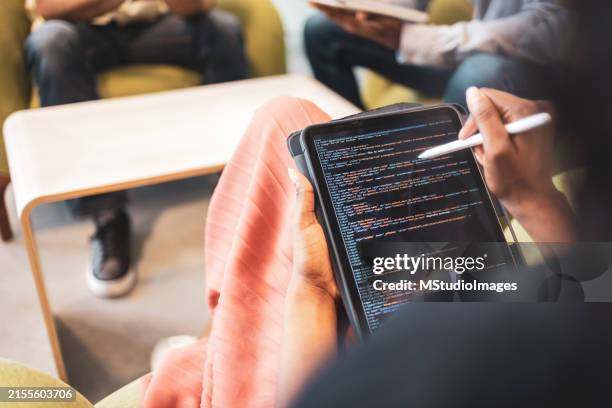 group of developers collaborating on a coding project. over the shoulder view - html stock pictures, royalty-free photos & images