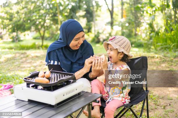 mother give a bread to her daughter - breakfast sausage stock pictures, royalty-free photos & images