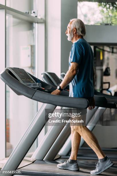 senior man exercising on treadmill at the gym - durability stock pictures, royalty-free photos & images