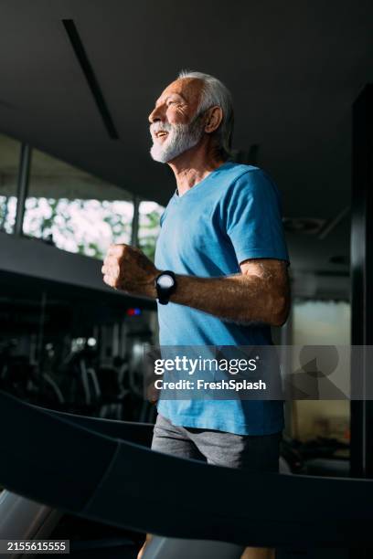 senior man running on treadmill in gym staying fit - durability stock pictures, royalty-free photos & images