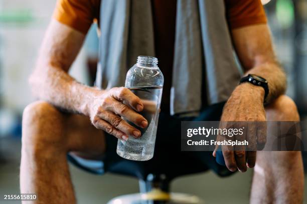 senior man hydrating during workout at gym - durability stock pictures, royalty-free photos & images