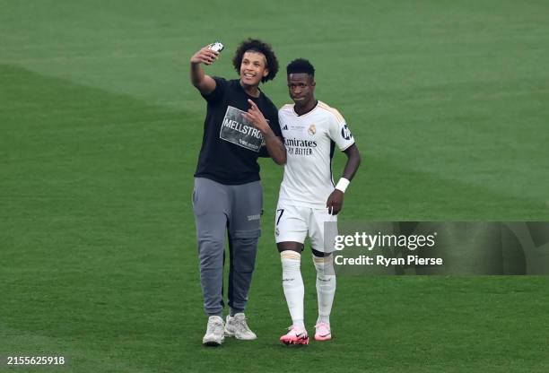Pitch invader attempts to take a selfie on a mobile phone with Vinicius Junior of Real Madrid during the UEFA Champions League 2023/24 Final match...