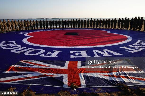 Military personnel attending a ceremony on Gold Beach in Arromanches in Normandy, France, to commemorate the 80th anniversary of the D-Day landings....