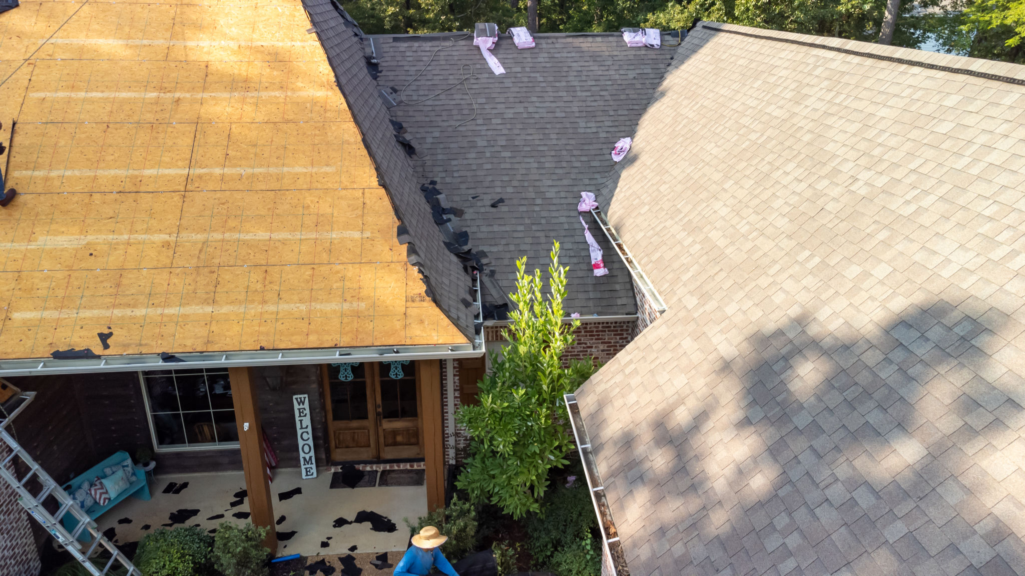 House with new roof being installed House with new roof being installed