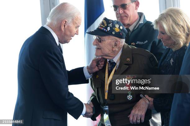 President Joe Biden and first lady Jill Biden greet American World War II veterans before a ceremony marking the 80th anniversary of D-Day at the...
