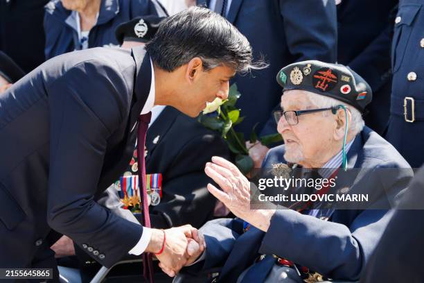 Britain's Prime Minister Rishi Sunak meets with a British D-Day veteran during the UK Ministry of Defence and the Royal British Legion's...