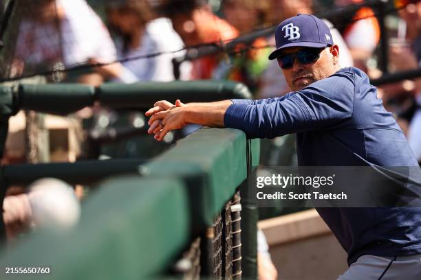 Manager Kevin Cash of the Tampa Bay Rays looks on from the dugout before the game against the Baltimore Orioles at Oriole Park at Camden Yards on...