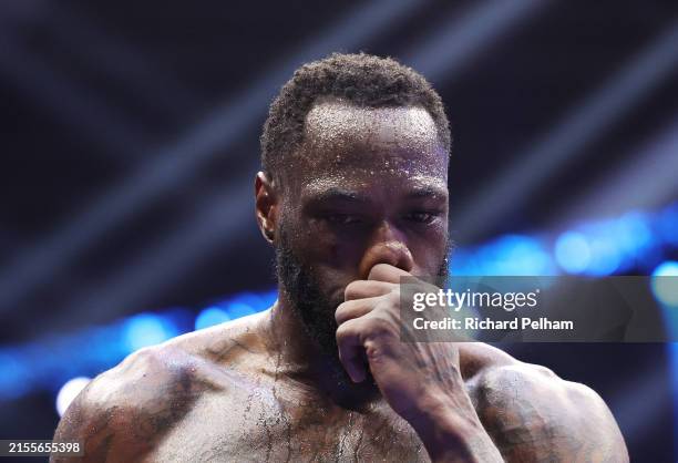 Deontay Wilder of Team Matchroom reacts after being knocked down by Zhilei Zhang of Team Queensberry during the Heavyweight fight between Deontay...