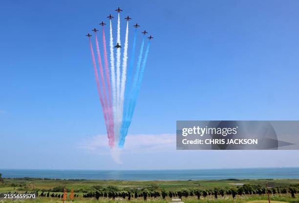 The British Royal Air Force's aerobatic team, the "Red Arrows" and a Eurofighter Typhoon perform a flypast during the UK Ministry of Defence and the...
