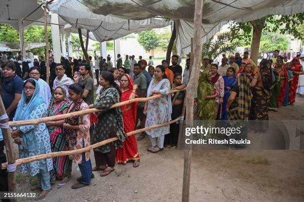 People stand in a queue to caste their vote during the seventh Phase of voting June 1, 2024 in Varanasi, India. India's 2024 general election is set...