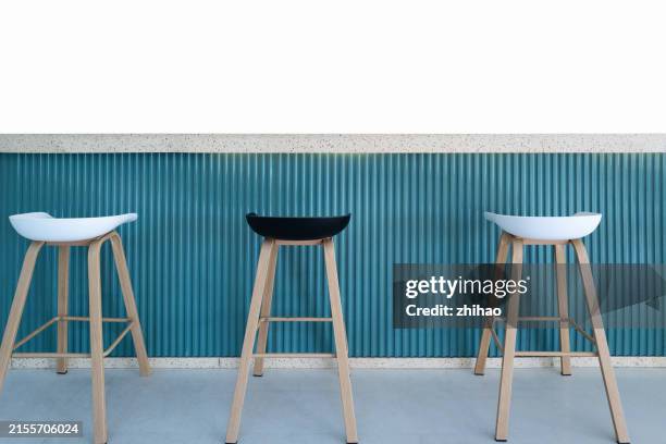 a row of bar stools - bar stool stock pictures, royalty-free photos & images