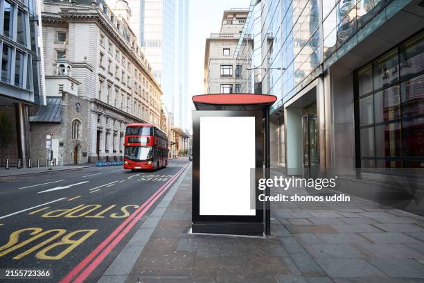 blank billboard at a bus stop in central london - promotion bus stock pictures, royalty-free photos & images