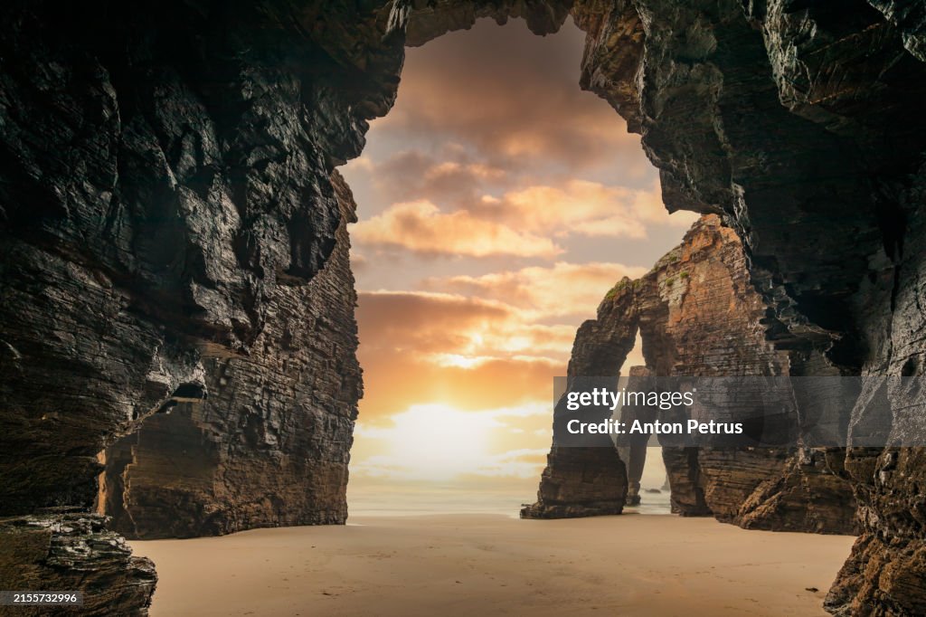 Natural rock arches on Cathedrals beach at sunset in low tide, Spain