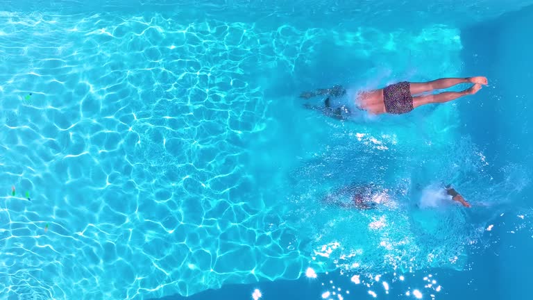 https://media.gettyimages.com/id/2155746800/video/aerial-slow-motion-view-of-a-holiday-couple-diving-into-the-swimming-pool.jpg?b=1&s=640x640&k=20&c=CZw96ENjyUB6YQPCeSaXBnM6v8Cv4mZ5yHkxnxsruyM=
