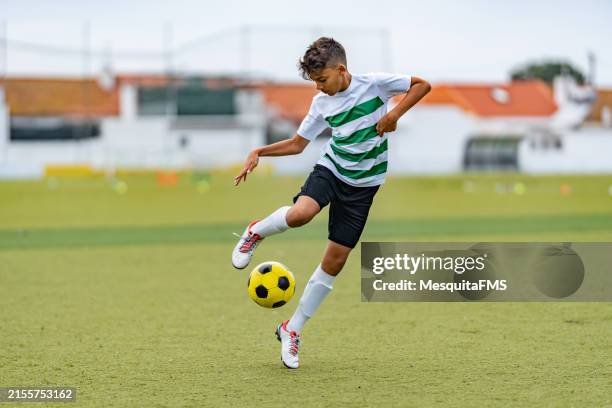 teenage boy playing soccer - child dribbling soccer ball stock pictures, royalty-free photos & images