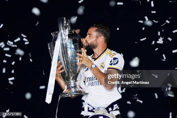 Nacho Fernandez of Real Madrid kisses the UEFA Champions League trophy during the Real Madrid UEFA Champions League Trophy Parade following their...