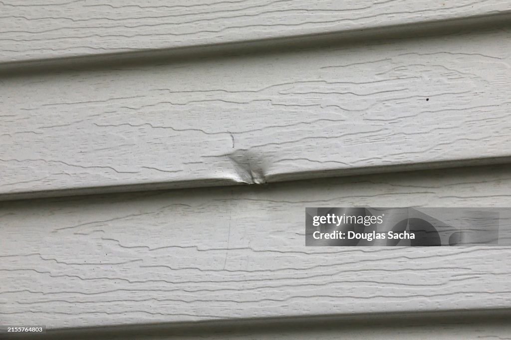 Damaged siding on a building wall