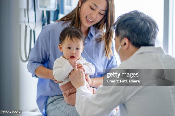 pediatric medical appointment - chinese canadian family stock pictures, royalty-free photos & images