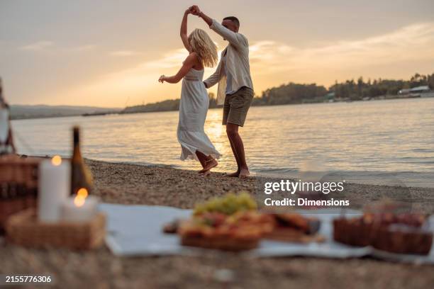 interracial couple swirling in dance by the river - couples romance stockfoto's en -beelden
