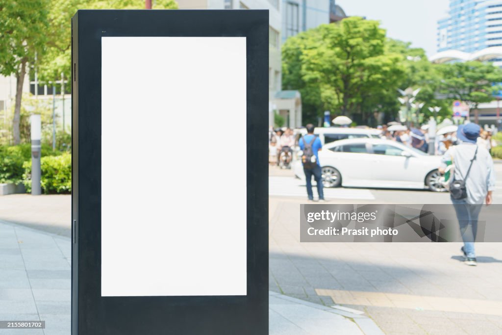 White mock up blank vertical billboard on the city street