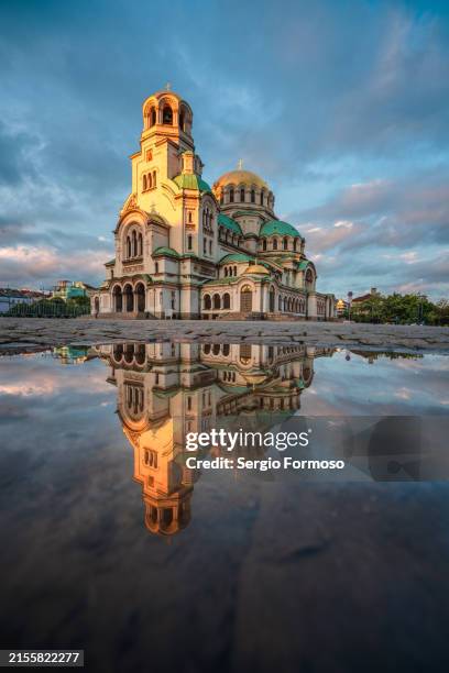 vertical view of alexander nevsky cathedral reflected on water in sofia, bulgaria, on a beautiful sunset - bulgaria stock pictures, royalty-free photos & images