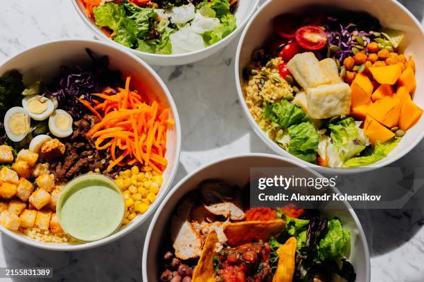salad bowls on light table. healthy lunch bowls. high angle view, flat lay - pflanzliche ernährung stock-fotos und bilder