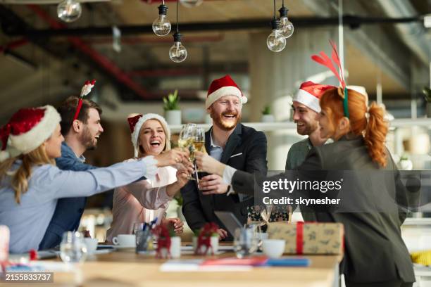 trinquer à la fête de bureau de noël ! - décembre photos et images de collection