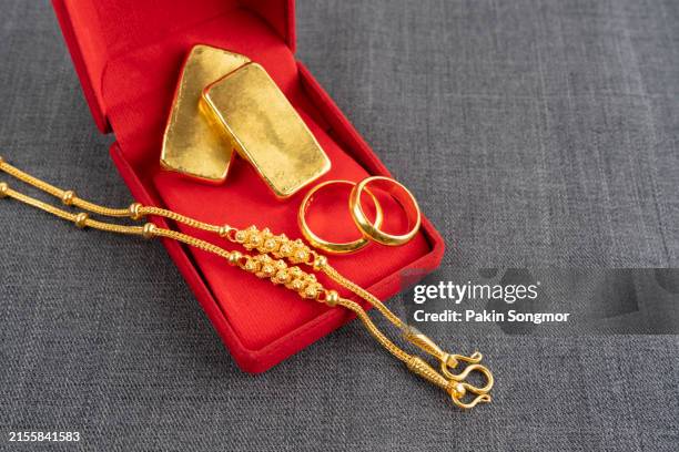 gold necklaces in a red velvet box on a black color textile - gold medal stock pictures, royalty-free photos & images