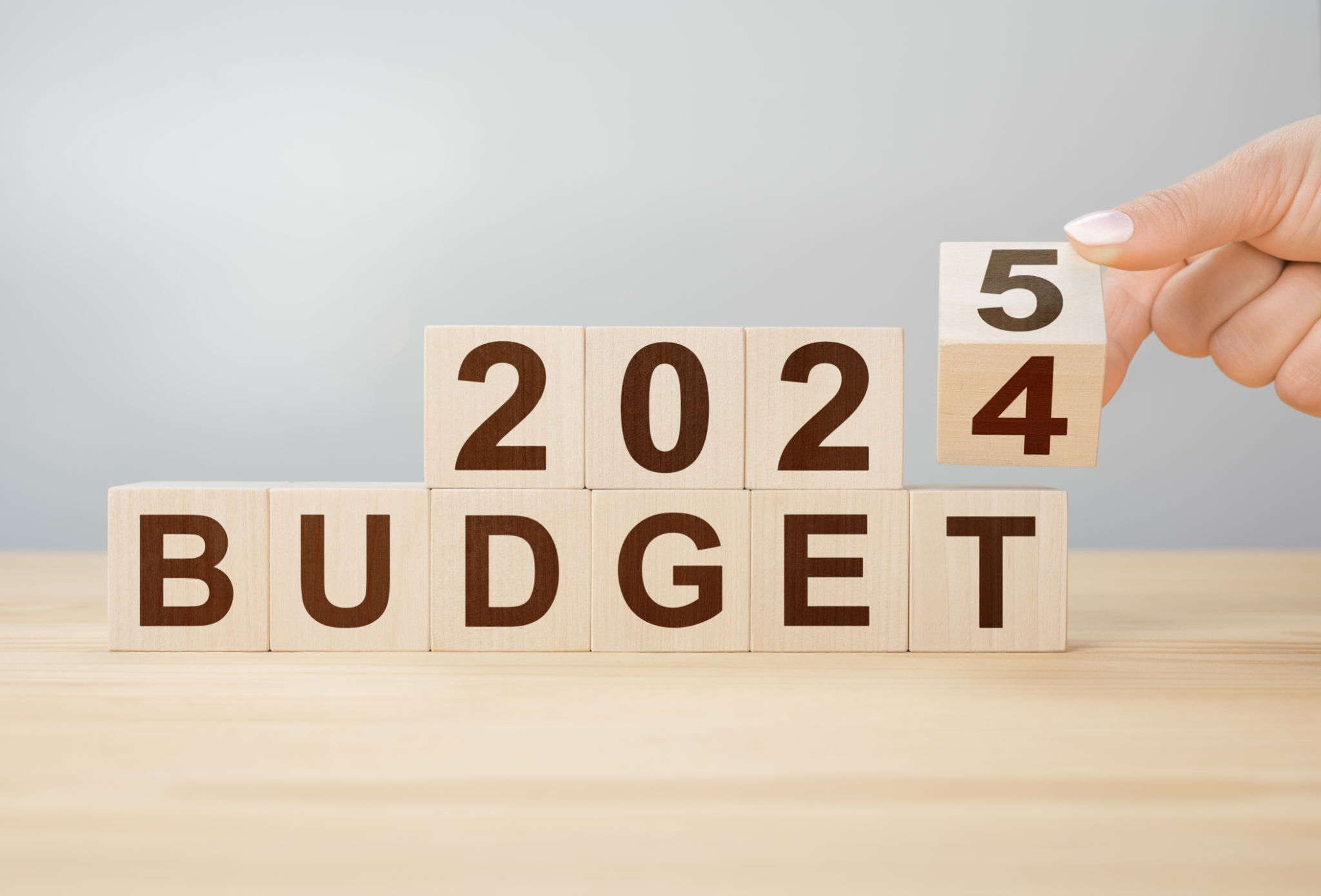 Business concept of planning 2025. Businessman flips wooden cube and changes words BUDGET 2024 to BUDGET 2025. New year business plan concept in 2025. Economy and business. 2025 BUDGET Business concept of planning 2025. Businessman flips wooden cube and changes words BUDGET 2024 to BUDGET 2025. New year business plan concept in 2025. Economy and business. 2025 BUDGET