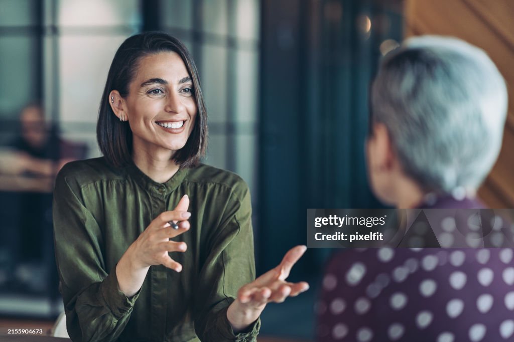 Two businesswomen talking in the office