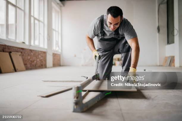 putting glue on tiles - tiler stock pictures, royalty-free photos & images