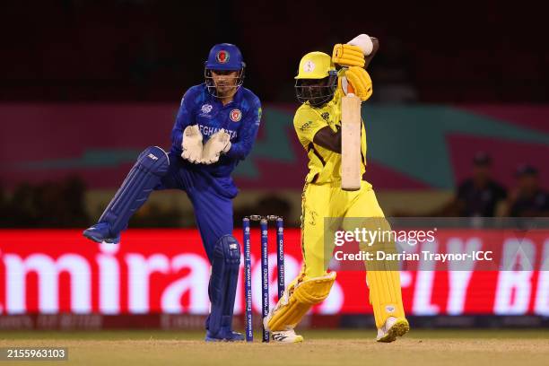 Robinson Obuya of Uganda bats as Rahmanullah Gurbaz of Afghanistan keeps during the ICC Men's T20 Cricket World Cup West Indies & USA 2024 match...