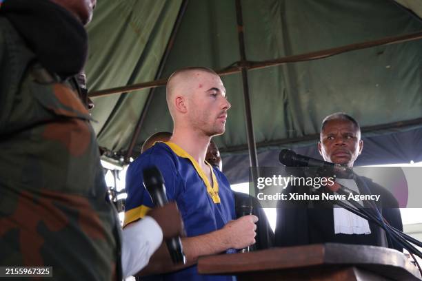 An alleged coup plotter stands trial before a military court in Kinshasa, the Democratic Republic of the Congo DRC, on June 7, 2024. Some 50 men,...