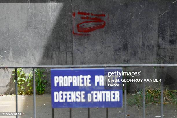 This photograph taken in the 7th arrondissement of Paris on June 8, 2024 shows a graffiti of coffins reading "French soldiers in Ukraine", behind a...