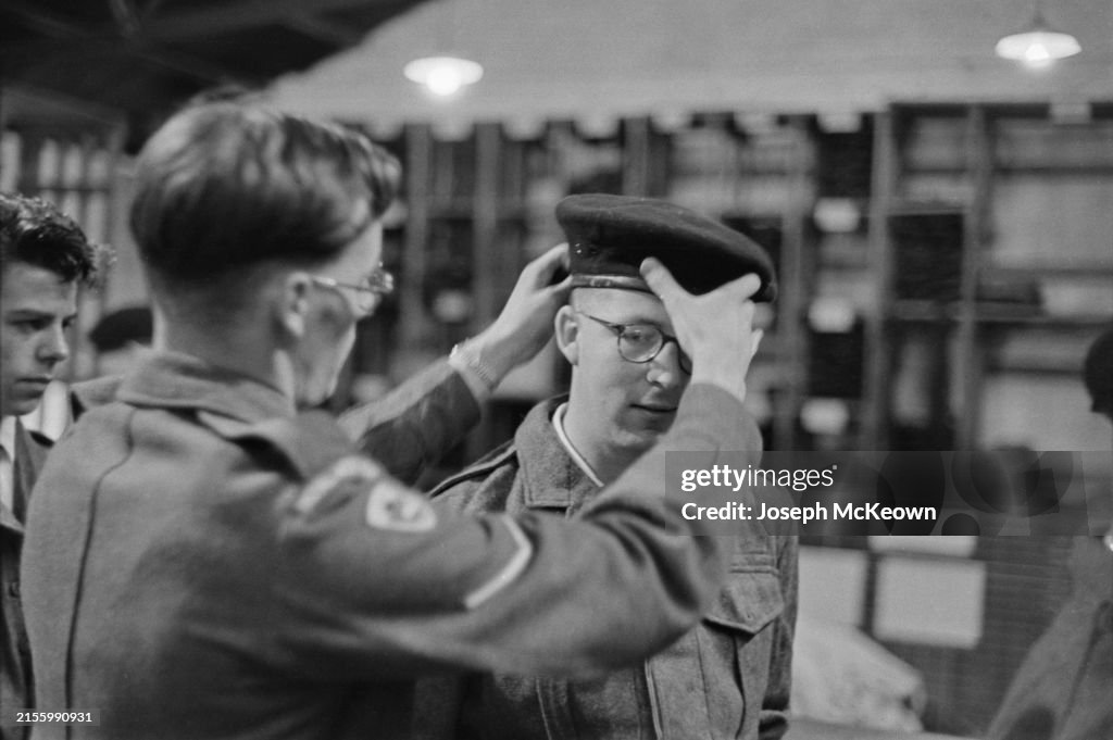 A young man conscripted for national service is trying on a military ...