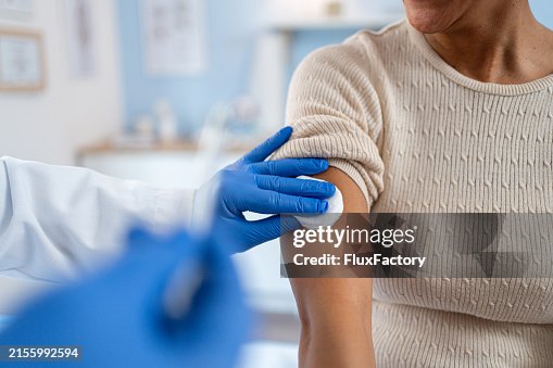 A medical technician performs vaccination A medical technician performs vaccination