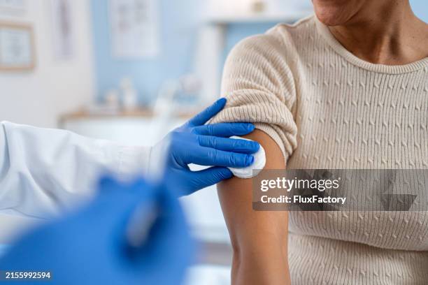 a medical technician performs vaccination - vaccination stock pictures, royalty-free photos & images