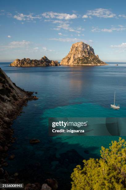 boat anchored in front of es vedra and es vedranell islands, sant josep de sa talaia, ibiza, balearic islands, spain - ibiza island stock pictures, royalty-free photos & images