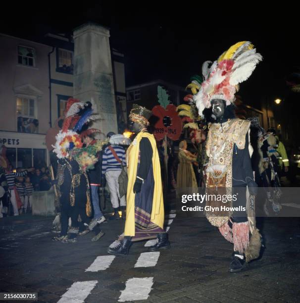 Members of the Lewes Borough Bonfire Society walk by the Lewes War Memorial during the bonfire celebrations street parade, East Sussex, November 1995.