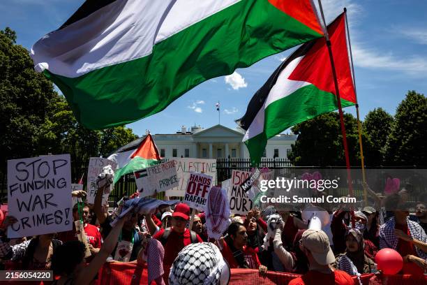 Pro-Palestinian activists wave Palestinian flags and chant on Pennsylvania Avenue in front of the White House during a demonstration protesting the...
