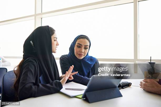 student discussing with teacher in university - arab women stock pictures, royalty-free photos & images