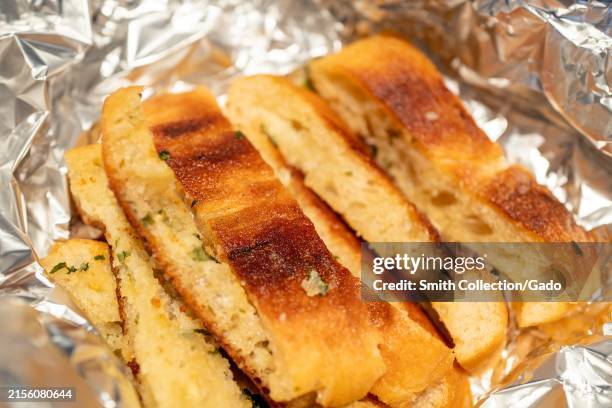 Slices of garlic bread in aluminum foil at Hazy Barbecue restaurant in Danville, California, June, 2024.