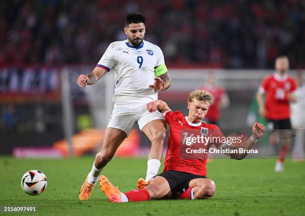 Aleksandar Mitrovic of Serbia battles for possession with Leopold Querfeld of Austria during the international friendly match between Austria and...