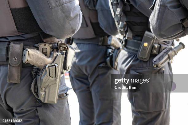 three german police officers and their equipment belts with gun - gun belt stock pictures, royalty-free photos & images